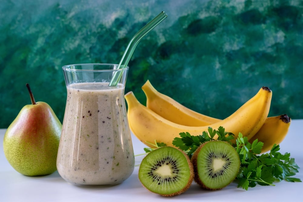 Banana kiwi fruit and pear blended into a smoothie